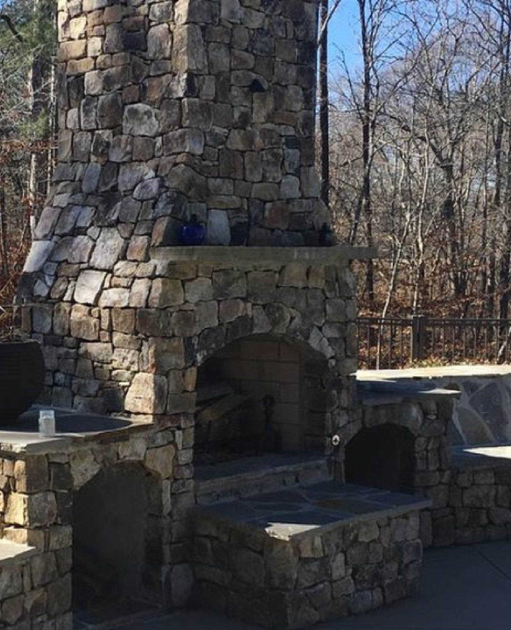 Outdoor stone fireplace built by Mancha Hardscapes