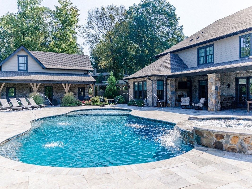 Gunite pool with a spillover spa and a covered patio