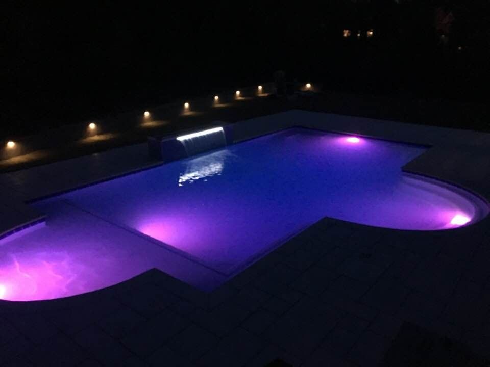Gunite pool with color LED lights at night